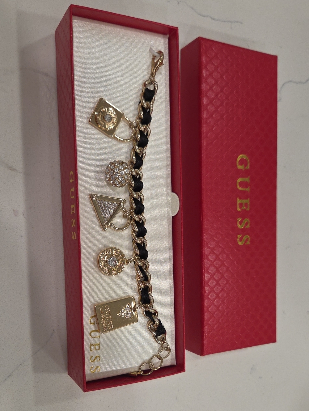 GUESS Gold and Black Charm Link Bracelet with Crystal Accents